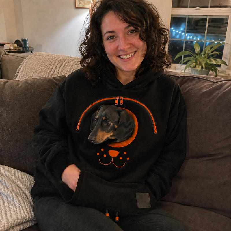 Jenna T. wearing the hoodie with their dog